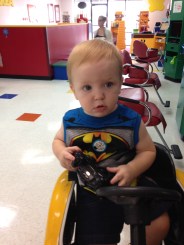 getting his haircut while watching Frozen in a toy car… kids' cuts places are adorable!