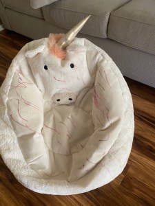 unicorn beanbag covered in pink dry erase marker